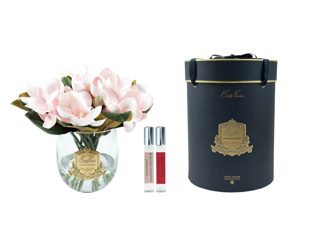 Pink magnolias diffuser in a glass with gold badge