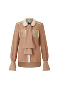 Tan blouse with contrast cream piping and draped scarf