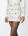 White trapeze mini skirt with embroidered rhinestone stars