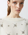 White sweater with embroidered rhinestone stars