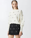 White sweater with embroidered rhinestone stars