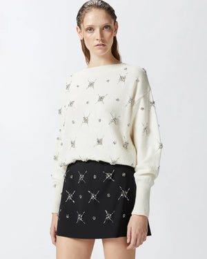 White sweater with embroidered rhinestone stars