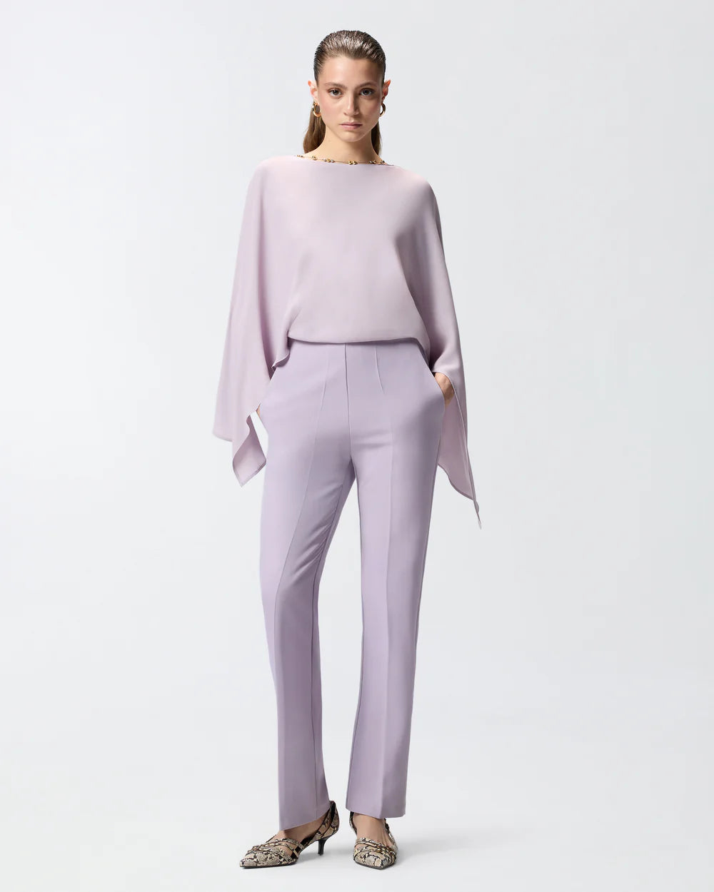 Lilac jumpsuit with open back and jeweled necklace
