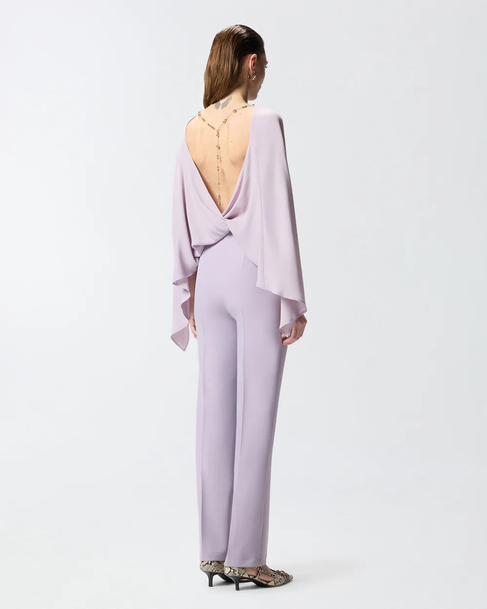 Lilac jumpsuit with open back and jeweled necklace