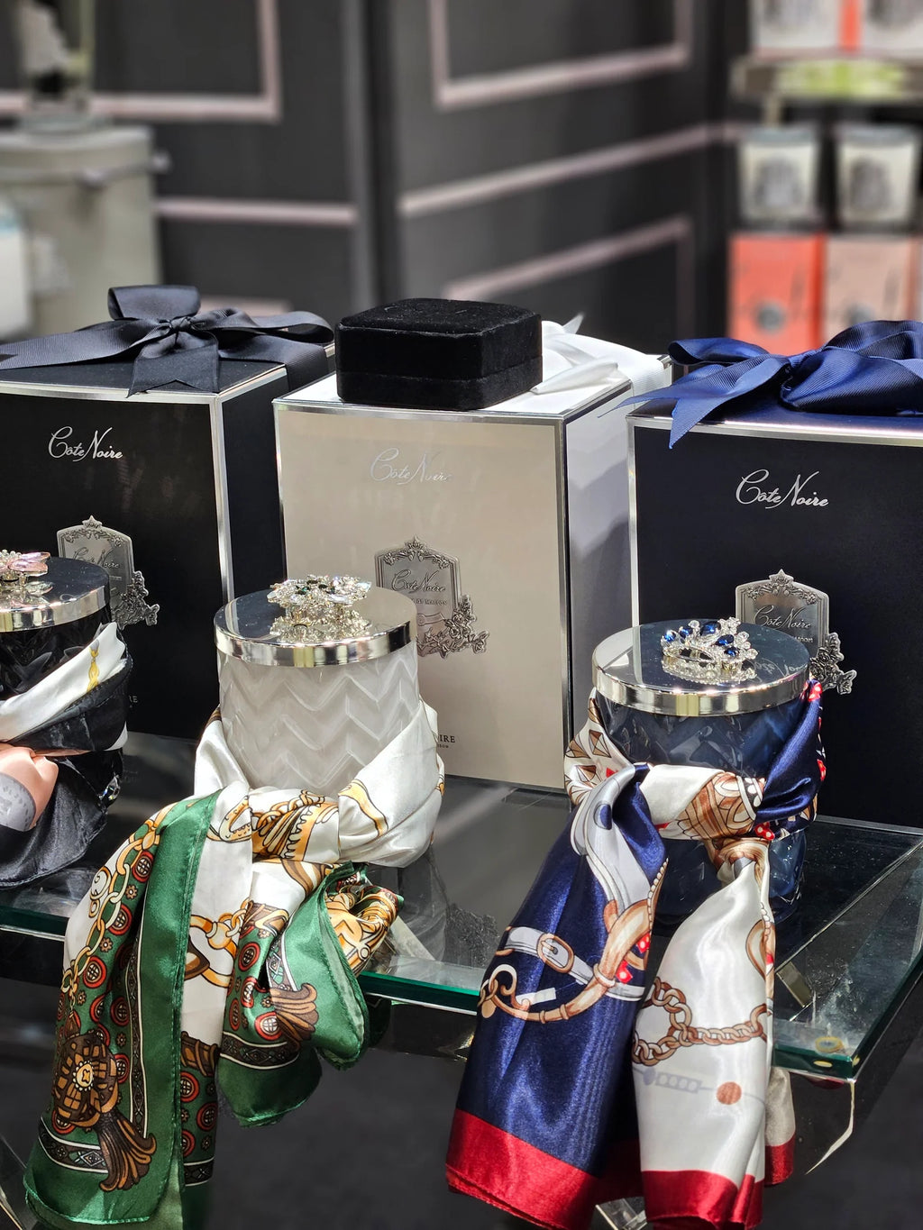 White herringbone candle with silk scarf and a silver broach