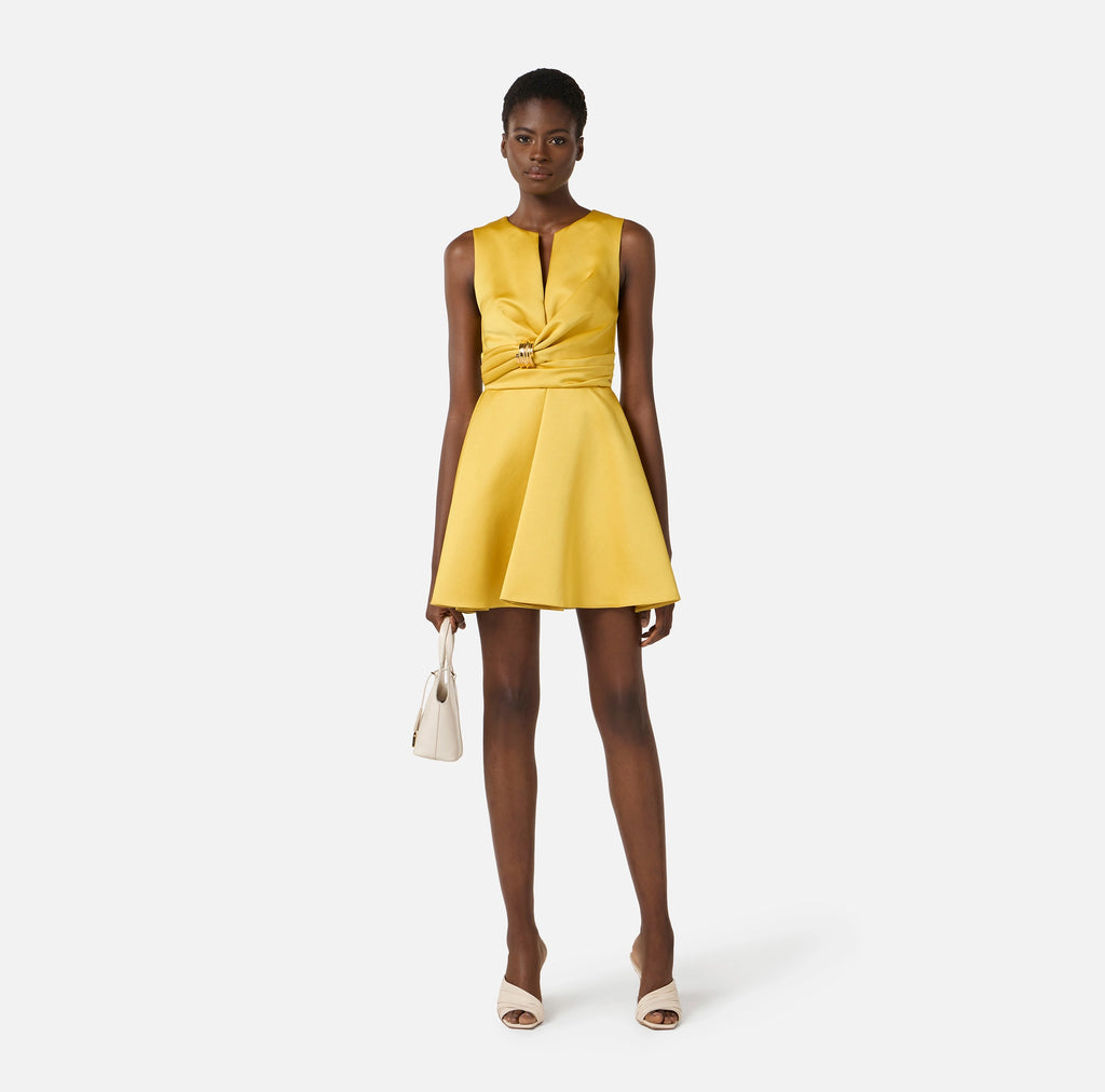 Yellow duchess satin dress with golden jewel