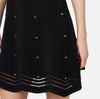 Black herringbone knit mini dress with gold grommet accents