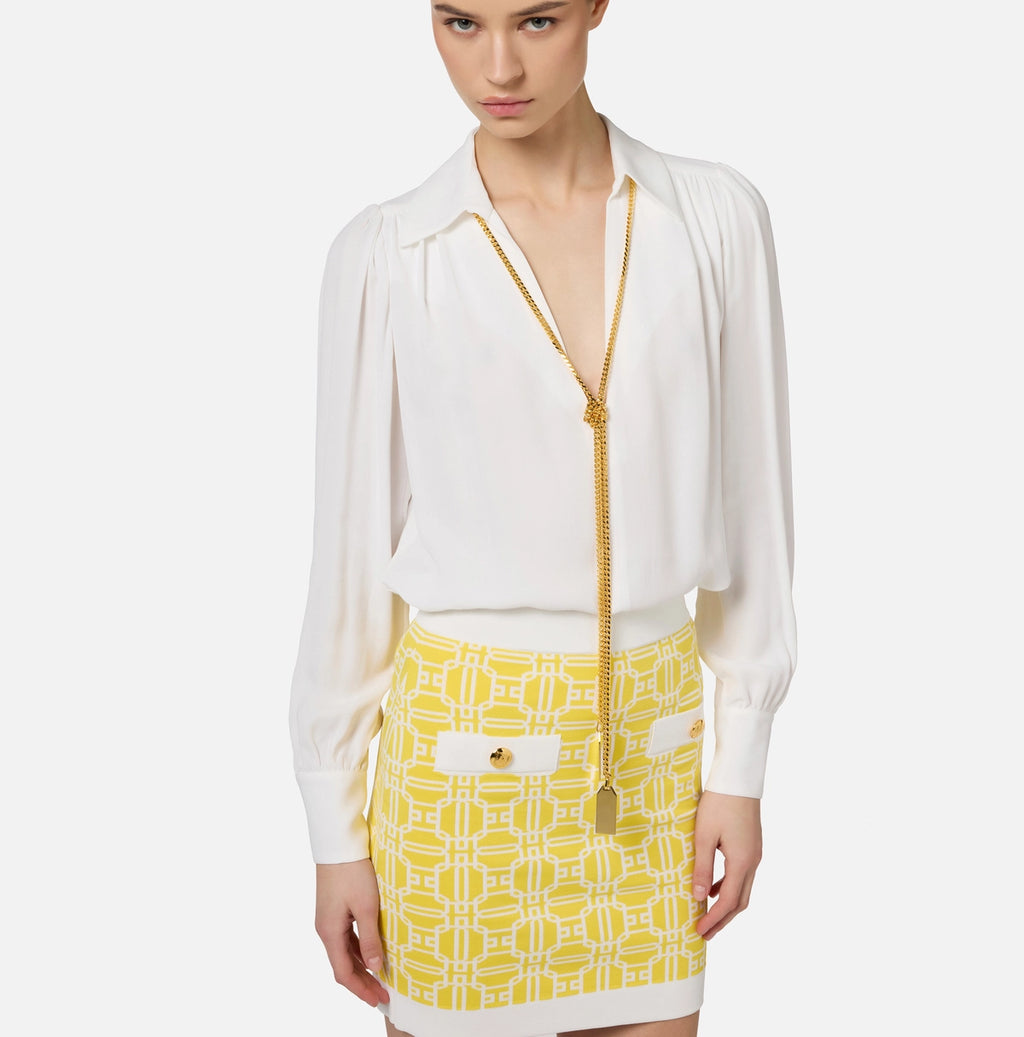 White long sleeve blouse with necklace