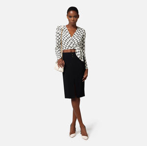 White and black cropped blouse with logo print and knot