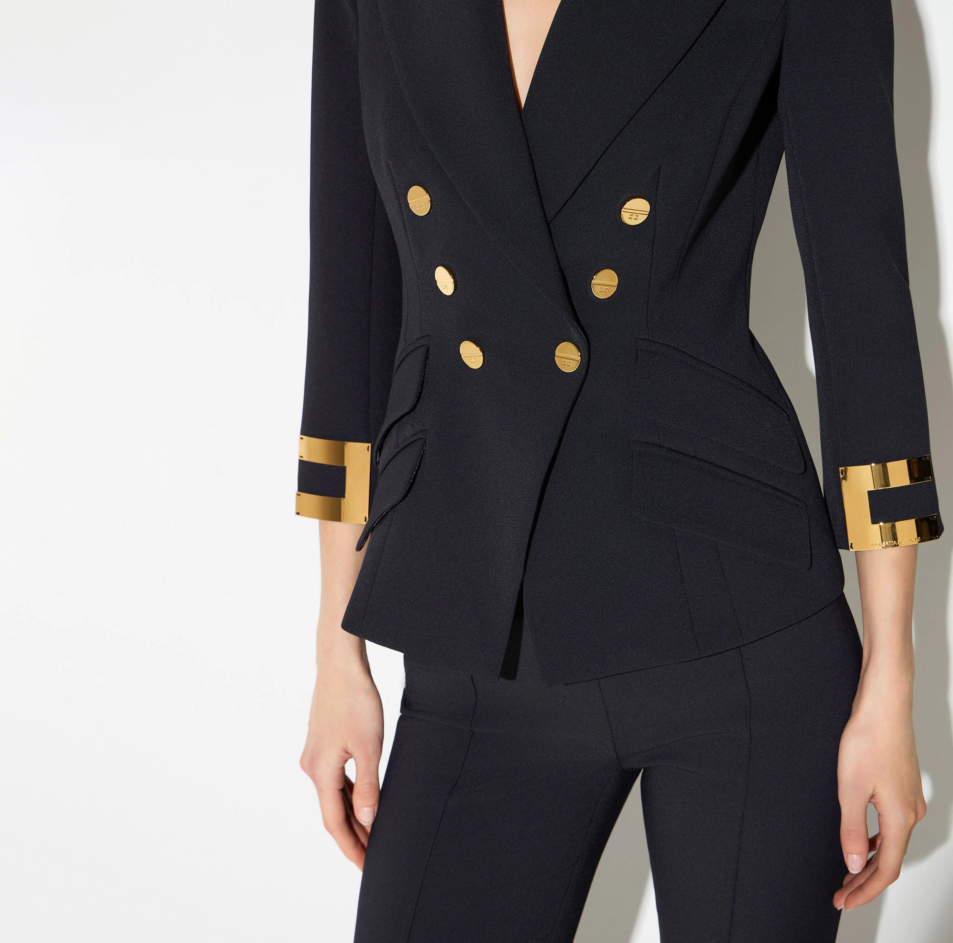 Navy structured jacket with gold buttons and logo details on sleeves