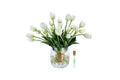 White heritage tulips in a clear vase with gold badge
