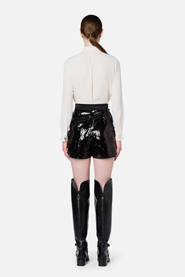 Black sequin shorts with a bow