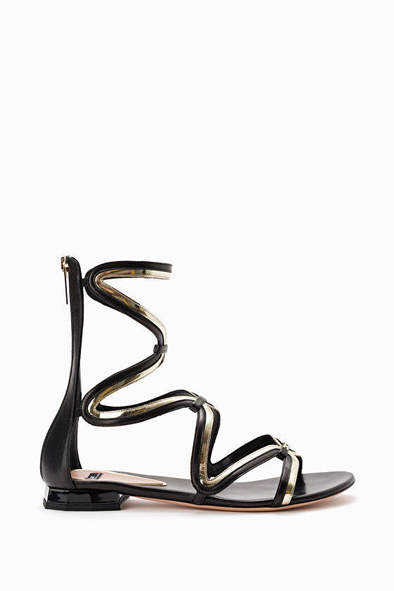 flat gladiator sandals in black and gold